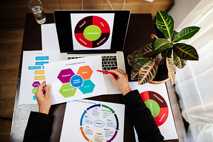 marketing product manager holding marketing promotion plan marketing product manager desk. Marketing mix plan for target market.